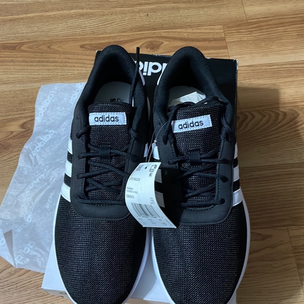 Adidas women’s sneakers. Brand new with tags. Black with white stripes.